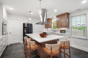 With the wall removed, the kitchen flows effortlessly into the surrounding space, perfect for entertaining.