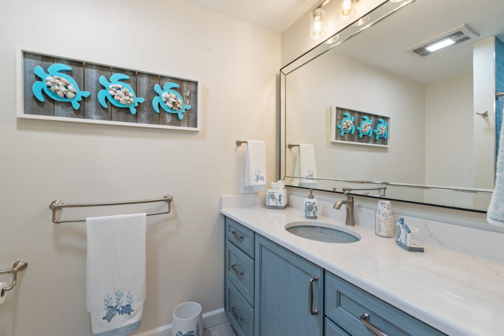 Shiloh Essex vanity in Sky stain paired with quartz countertop and Kohler Bluestone Rutile sink.