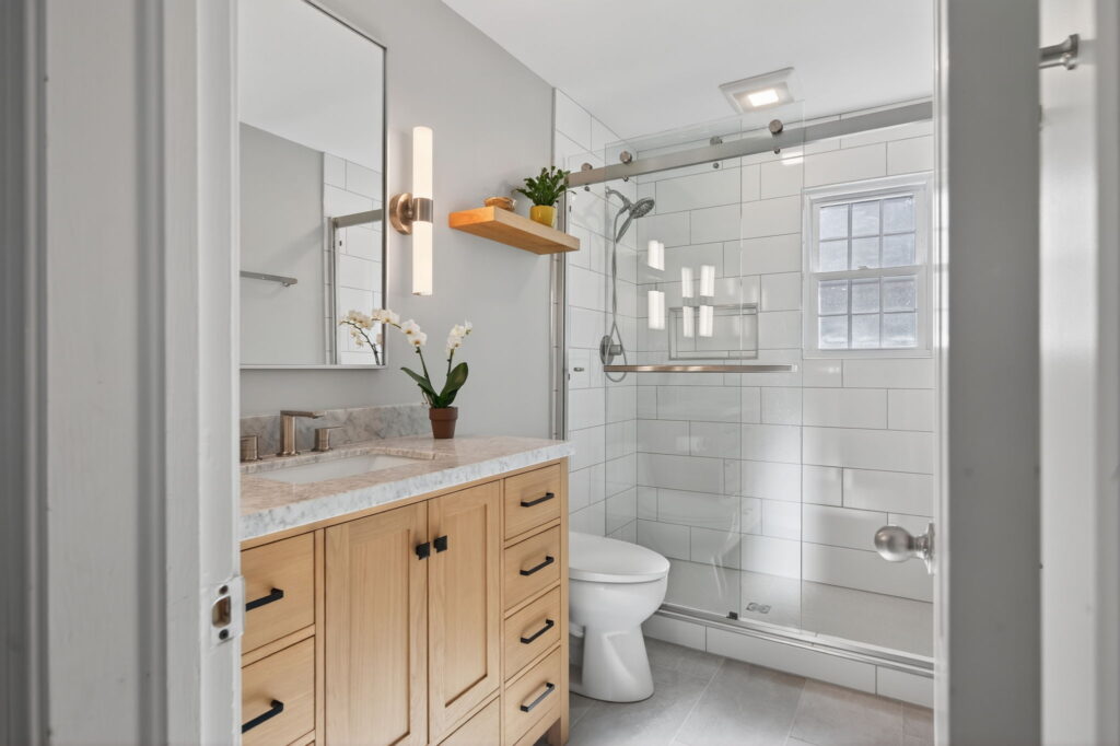 Fully remodeled Norfolk bathroom featuring clean modern design and improved use of space.