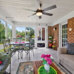 Interior of a Betterliving sunroom with expansive insulated windows overlooking a landscaped backyard.