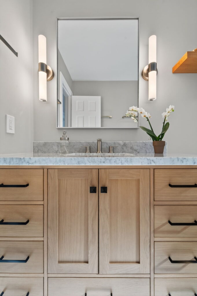 Sleek new vanity with quartz countertops and modern cabinetry offering more storage and visual appeal.