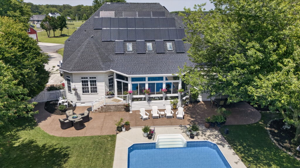 Aerial photo of custom sunroom, deck, landing, and roof