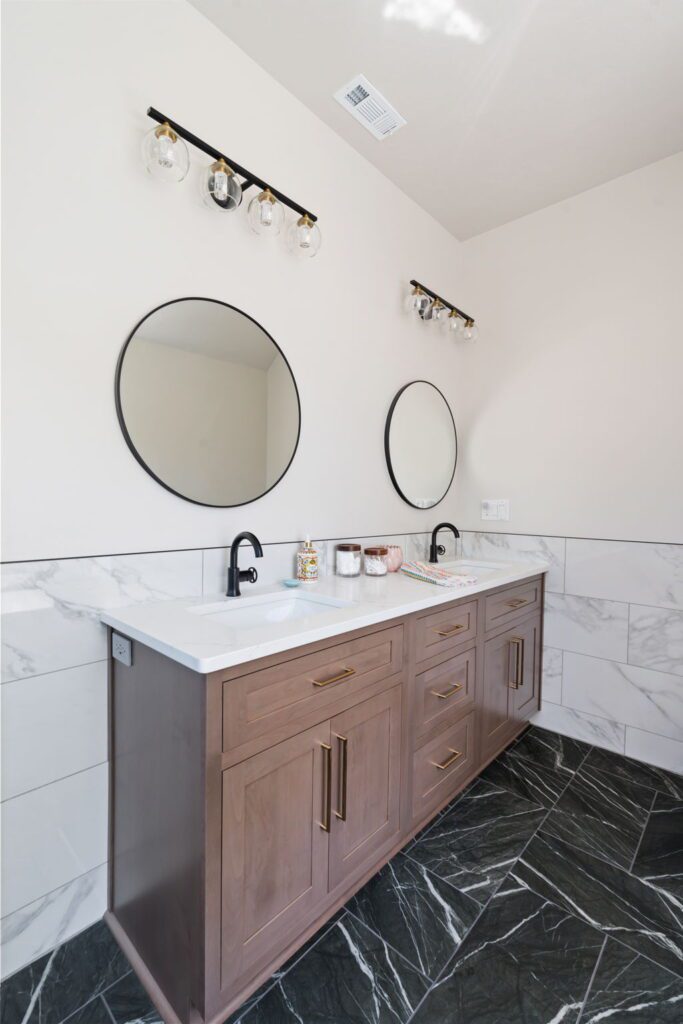 modern vanity with black marbled tile