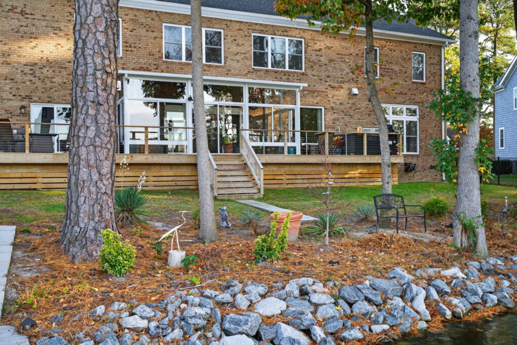 Elegant lakeside sunroom offering a comfortable space for cooking, entertaining, and relaxing by the water.