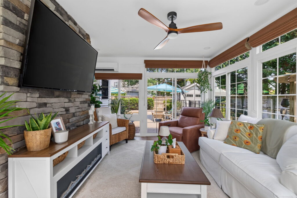 Custom fireplace and comfortable seating in a Virginia Beach sunroom