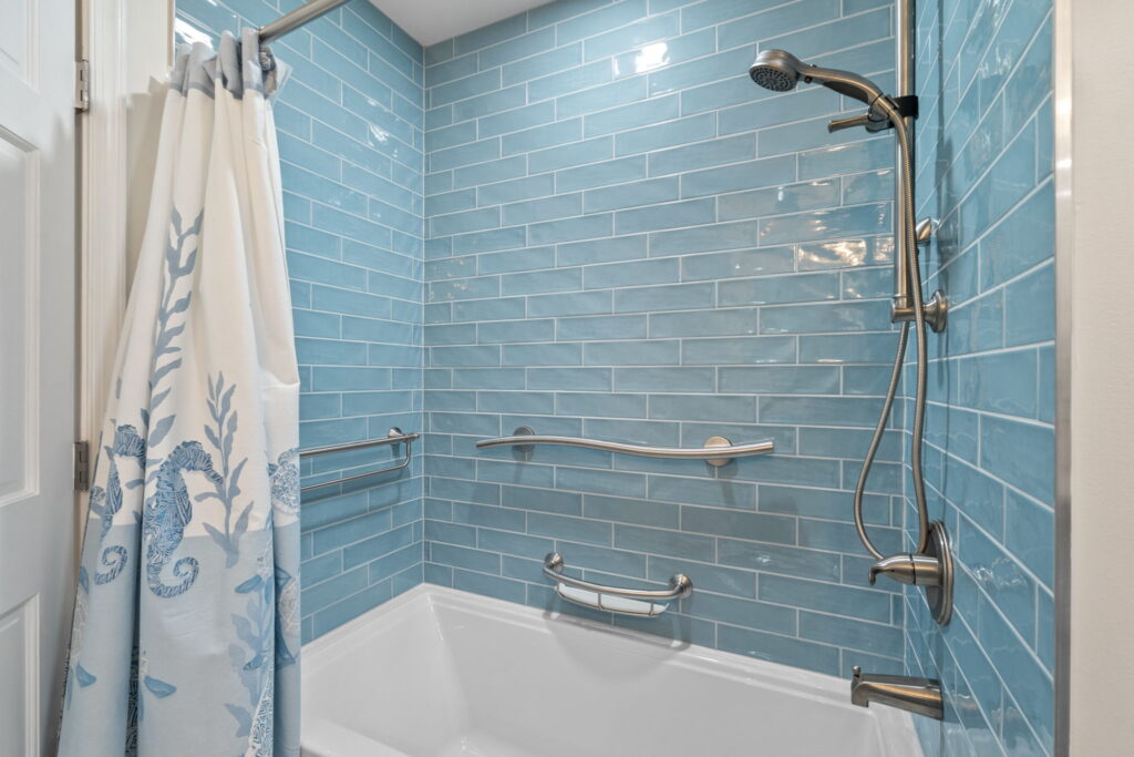 Shower featuring Albatross Tile in Sky color with modern coastal-inspired bathroom design.