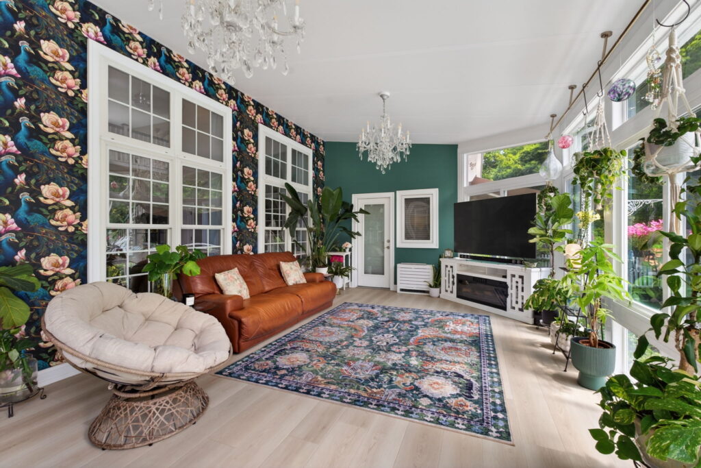 Custom peacock wallpaper inside luxury Chesapeake sunroom addition.