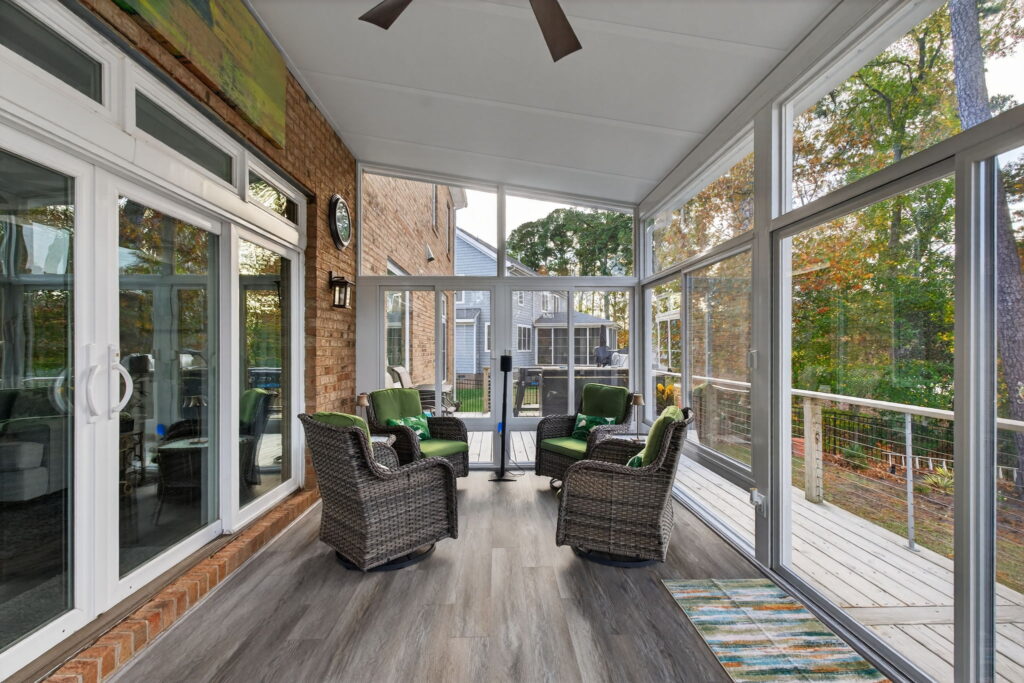 Interior view of the 3-season Betterliving Sunroom with bright natural light and scenic lake backdrop.