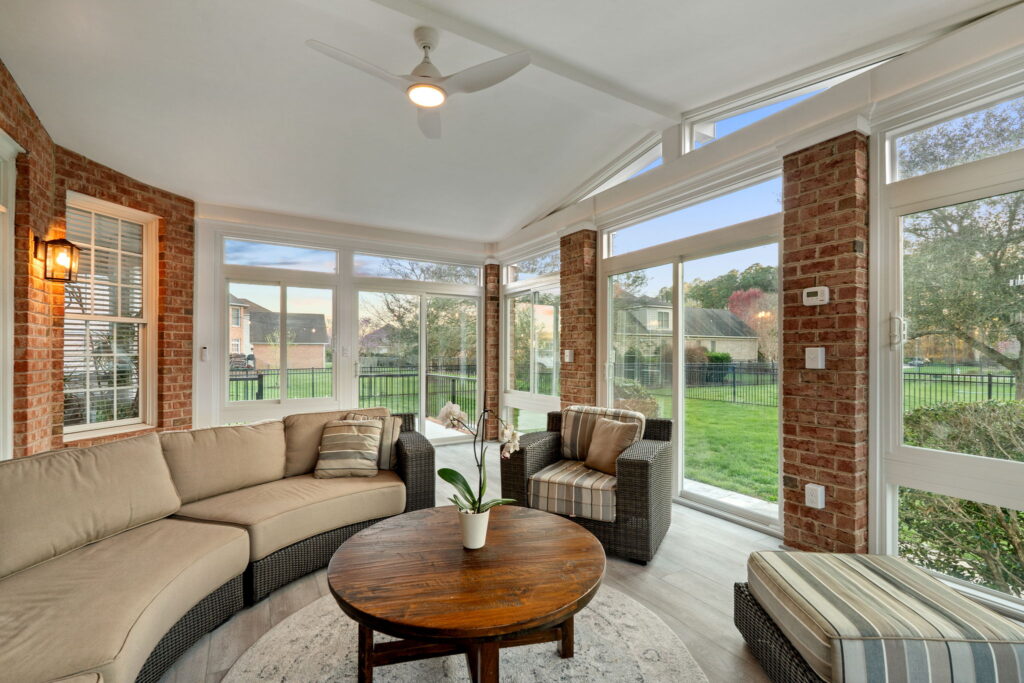 Interior of 4 season sunroom with exposed brick
