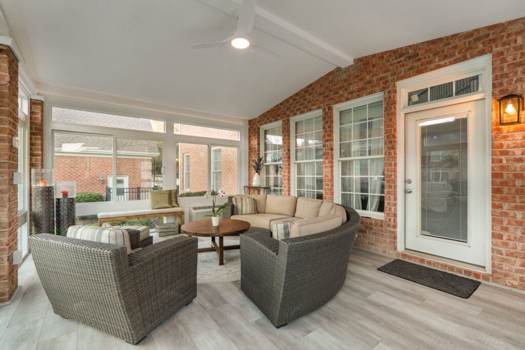 Interior of 4 season sunroom with exposed brick