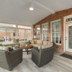 Interior of 4 season sunroom with exposed brick