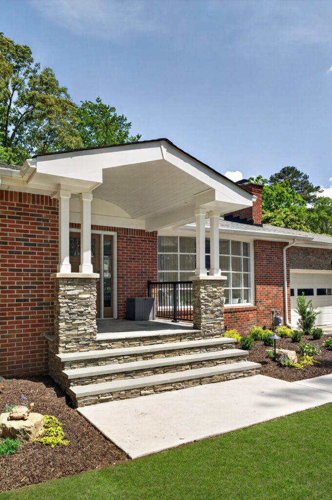 Newly remodeled front entryway with covered portico and custom masonry details on residential home