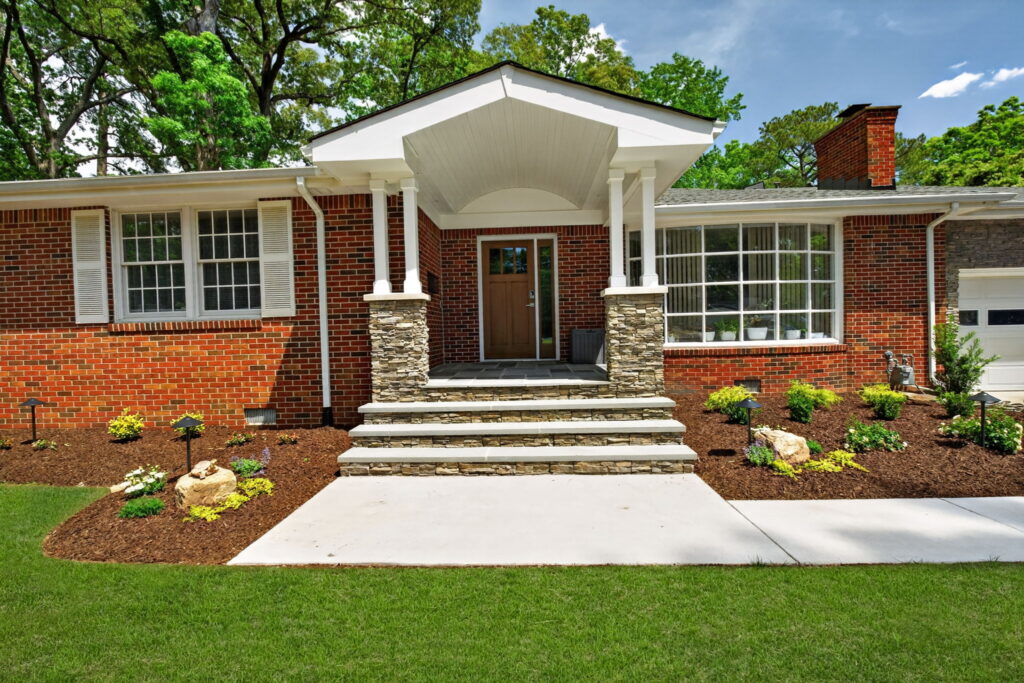Custom portico entrance with stone masonry and upgraded front door completed by McDrake Remodeling in Hampton Roads