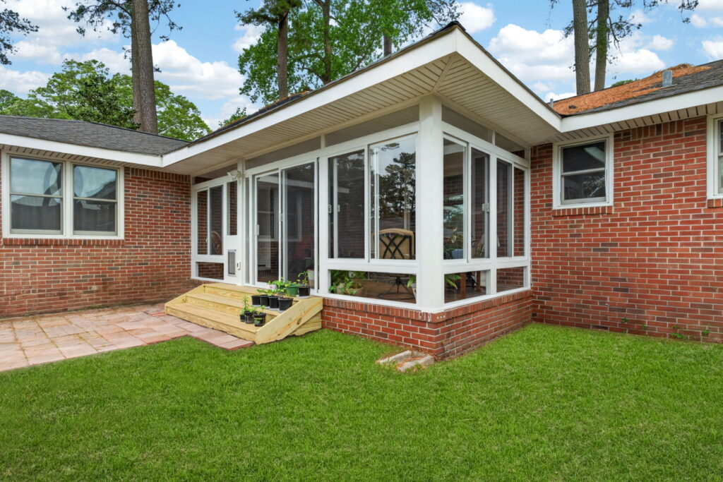Existing covered porch converted into a comfortable 3 season sunroom by Betterliving Sunrooms & Awnings of Hampton Roads.