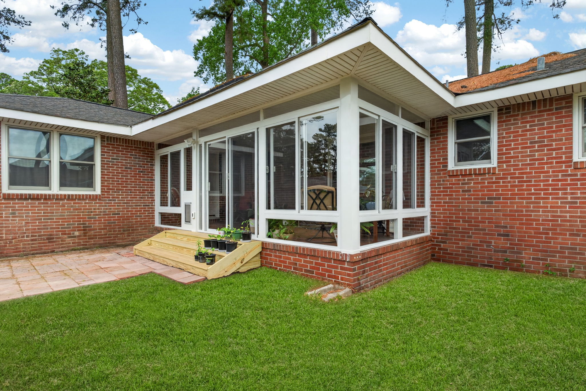 Existing covered porch converted into a comfortable 3 season sunroom by Betterliving Sunrooms & Awnings of Hampton Roads.