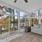Interior view of the 3-season Betterliving Sunroom with bright natural light and scenic lake backdrop.