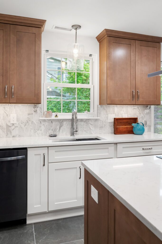 Custom Green Forest Park Place cabinets in Bianco and Smoked Cashew go in, adding texture and contrast.