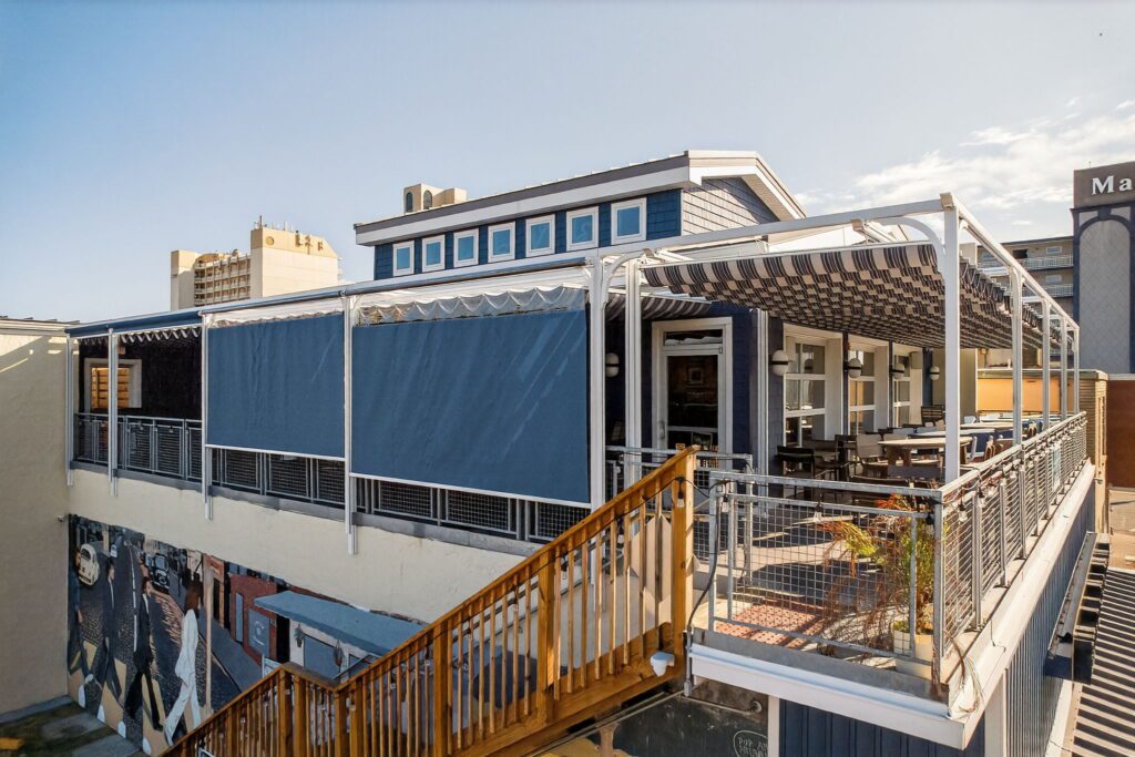 Motorized solar shades for blocking sun glare and reducing wind