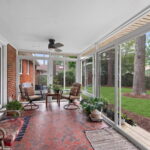 Bright and airy 3 season sunroom overlooking a backyard garden and birdwatching area in Norfolk, Virginia.