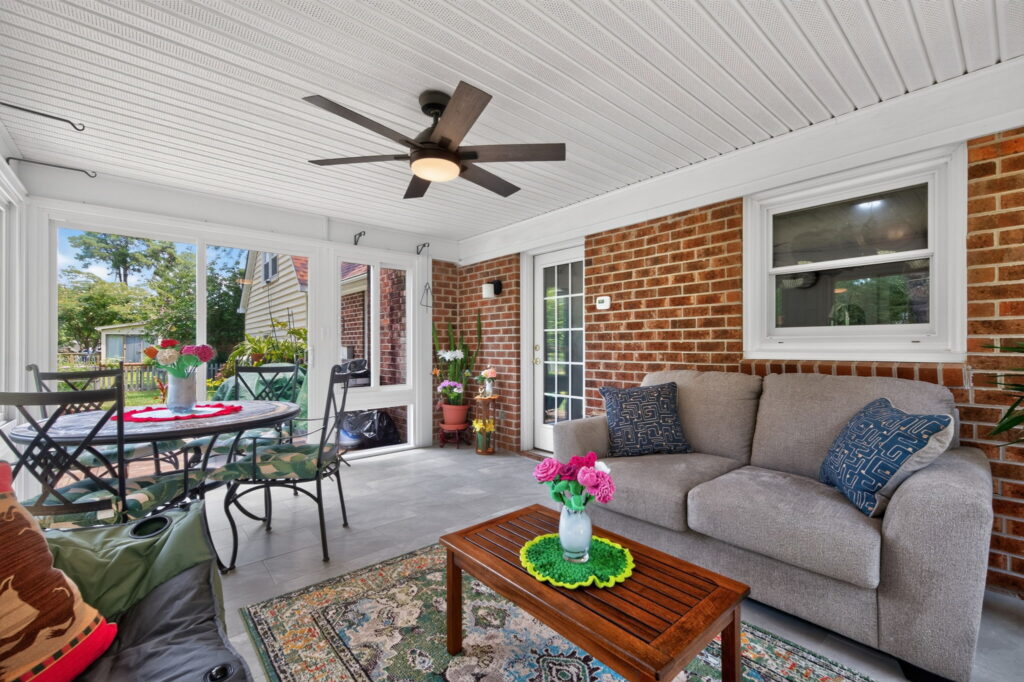 Sun-filled four-season sunroom providing comfortable indoor-outdoor living throughout the year.