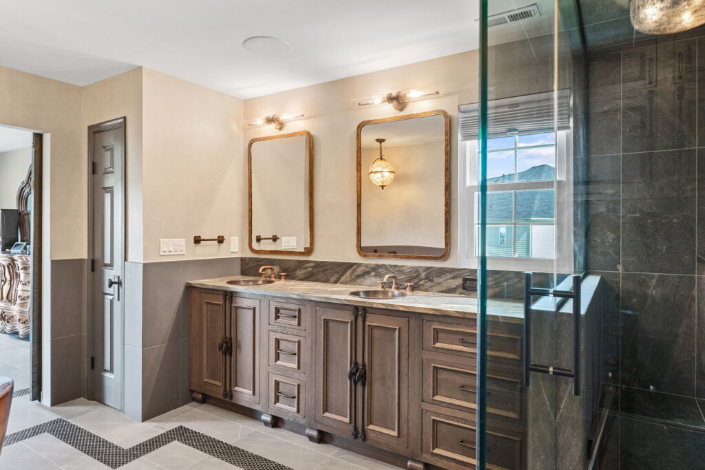 Steampunk inspired double-vanity sink, brass mirrors, and custom tile work