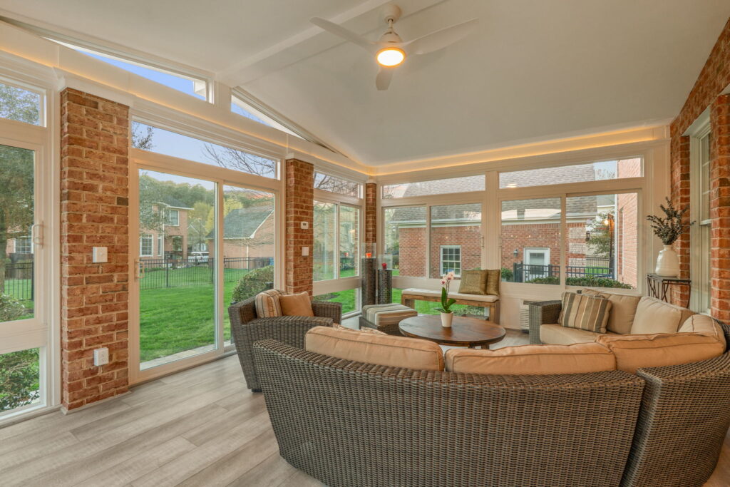 Interior of 4 season sunroom with exposed brick and crown molding lighting