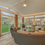 Interior of 4 season sunroom with exposed brick and crown molding lighting