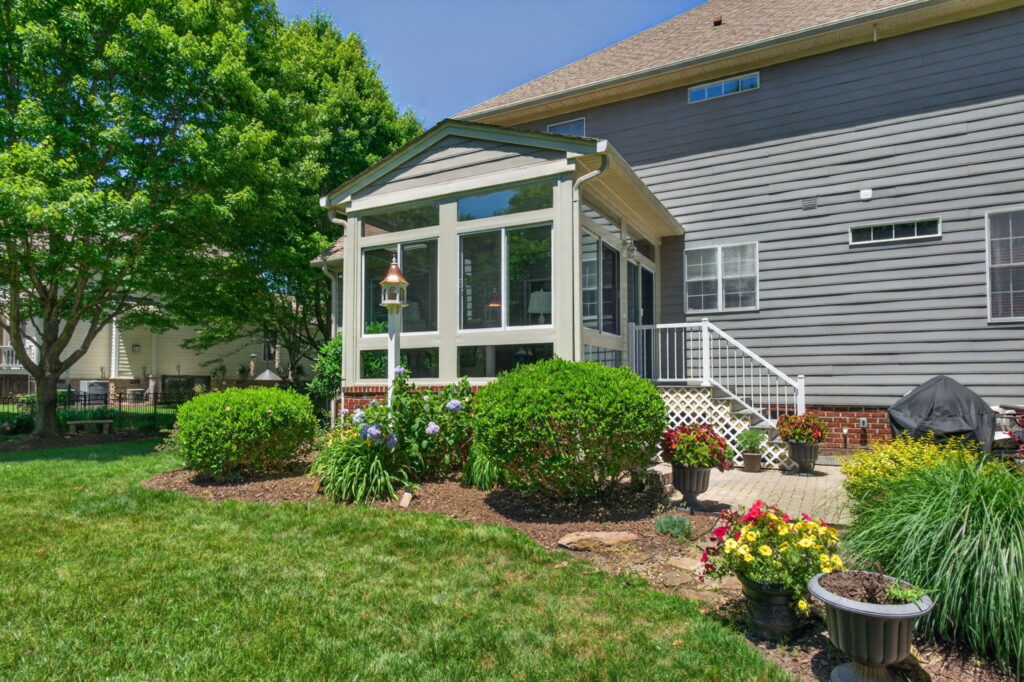 Completed sunroom addition creating a year-round retreat with views of gardens, deer, wild turkeys, and mature trees.