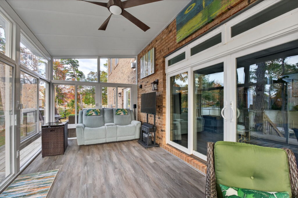 Betterliving 3-season sunroom seamlessly integrated with the home’s existing architecture and deck.