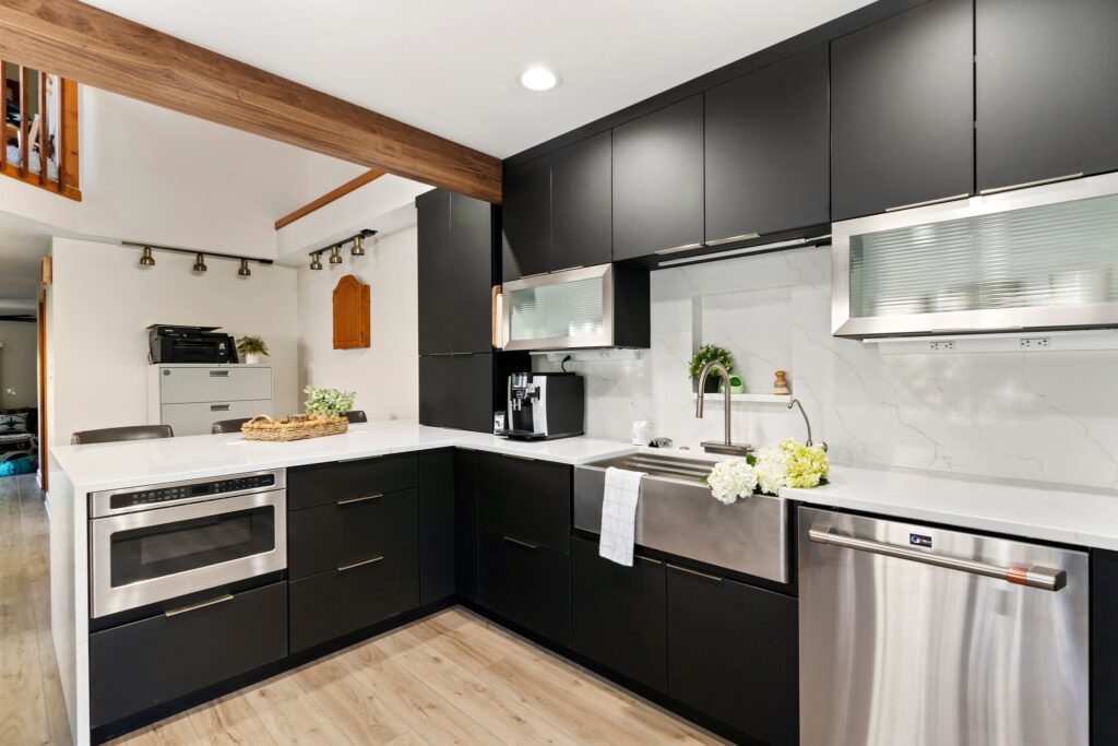 exposed wood beam in kitchen remodel with black matte cabinetry