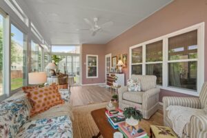 Sunroom with lounge area and natural sunlight - highlights the comfort of a climate-controlled space.