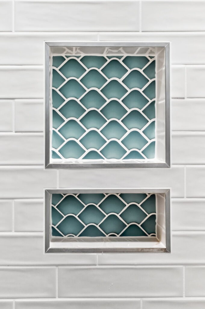 Glazzio Mermaids Collection tile and custom shower niche in remodeled bathroom