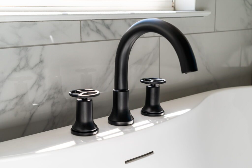 matt black hardware on soaking bathtub