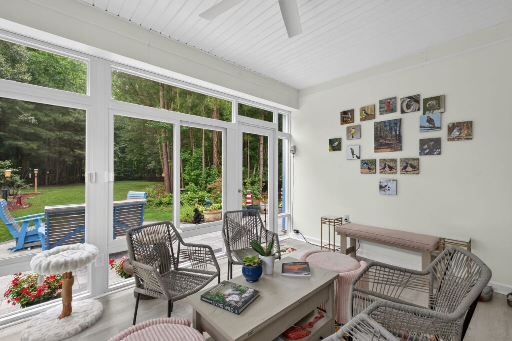 Sunroom with wood-lined views and bird photography gallery