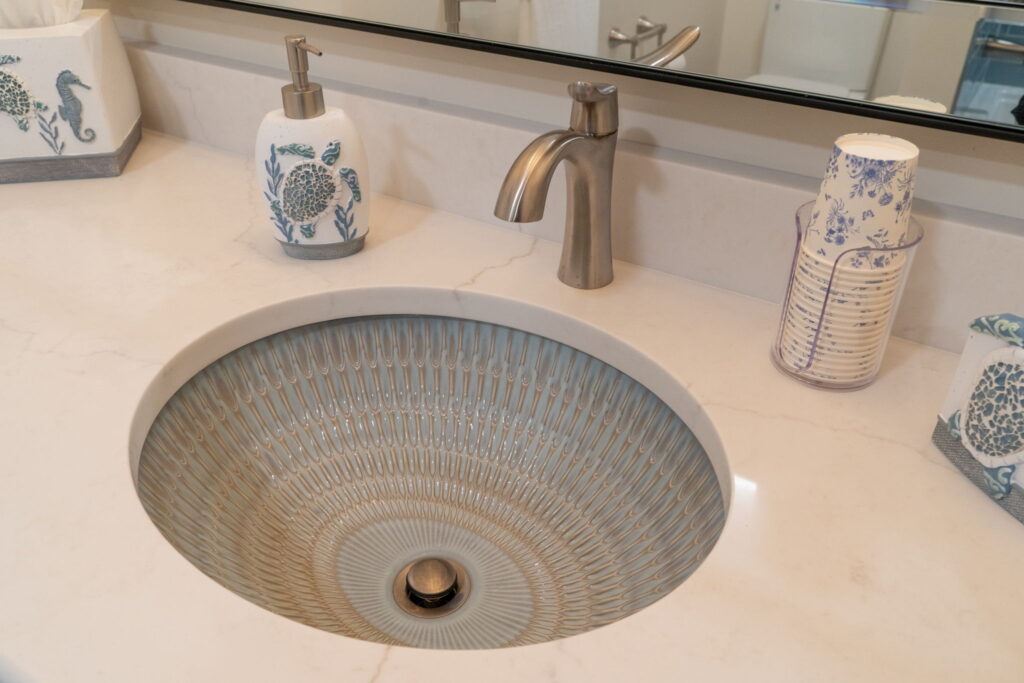 Shiloh Essex vanity in Sky stain paired with quartz countertop and Kohler Bluestone Rutile sink.