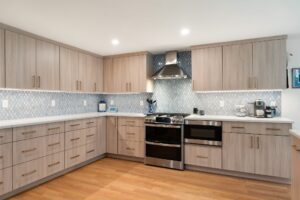 Natural Elm Cabinetry with Bronze Hardware and Calacatta Quartz Countertops