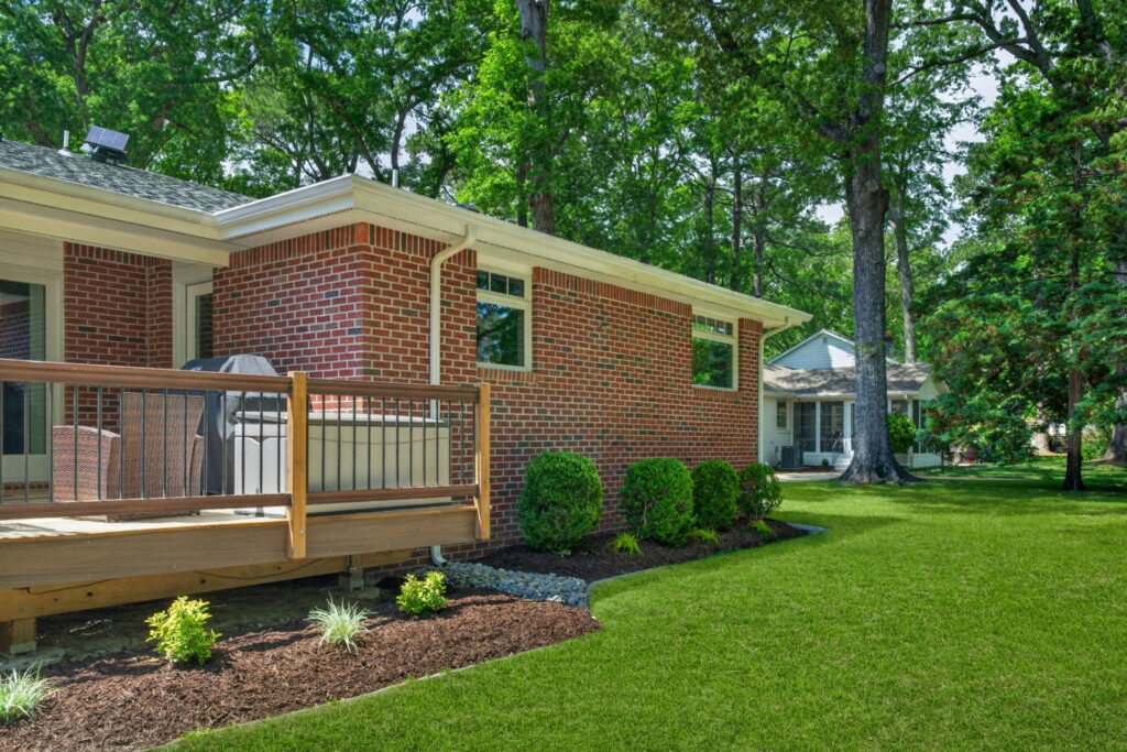 Bathroom addition connected to backyard deck designed for entertaining and family gatherings