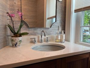 The first-floor powder room is a standout example of how small spaces can shine with the right materials and details. Just because a room is compact doesn’t mean it shouldn’t be luxurious.