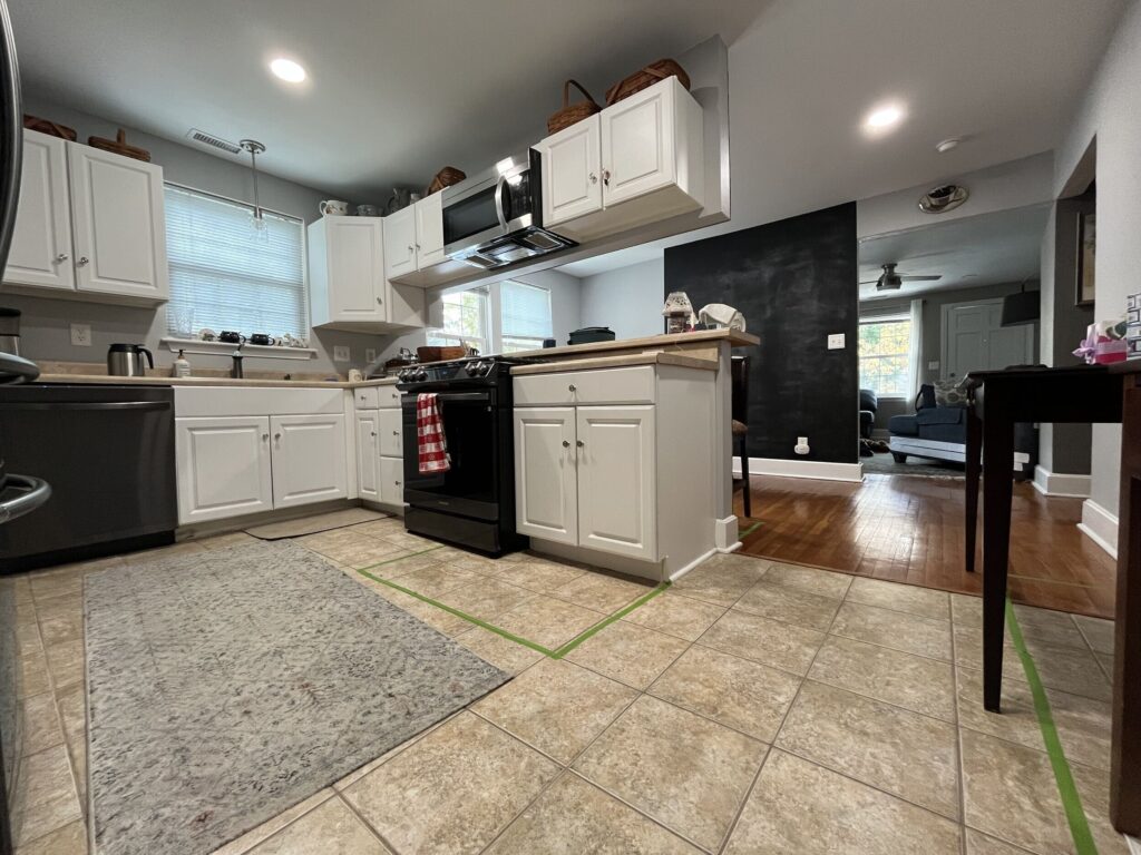 The old tile flooring had deep grout lines and a textured surface that was hard to keep clean — time for an upgrade.