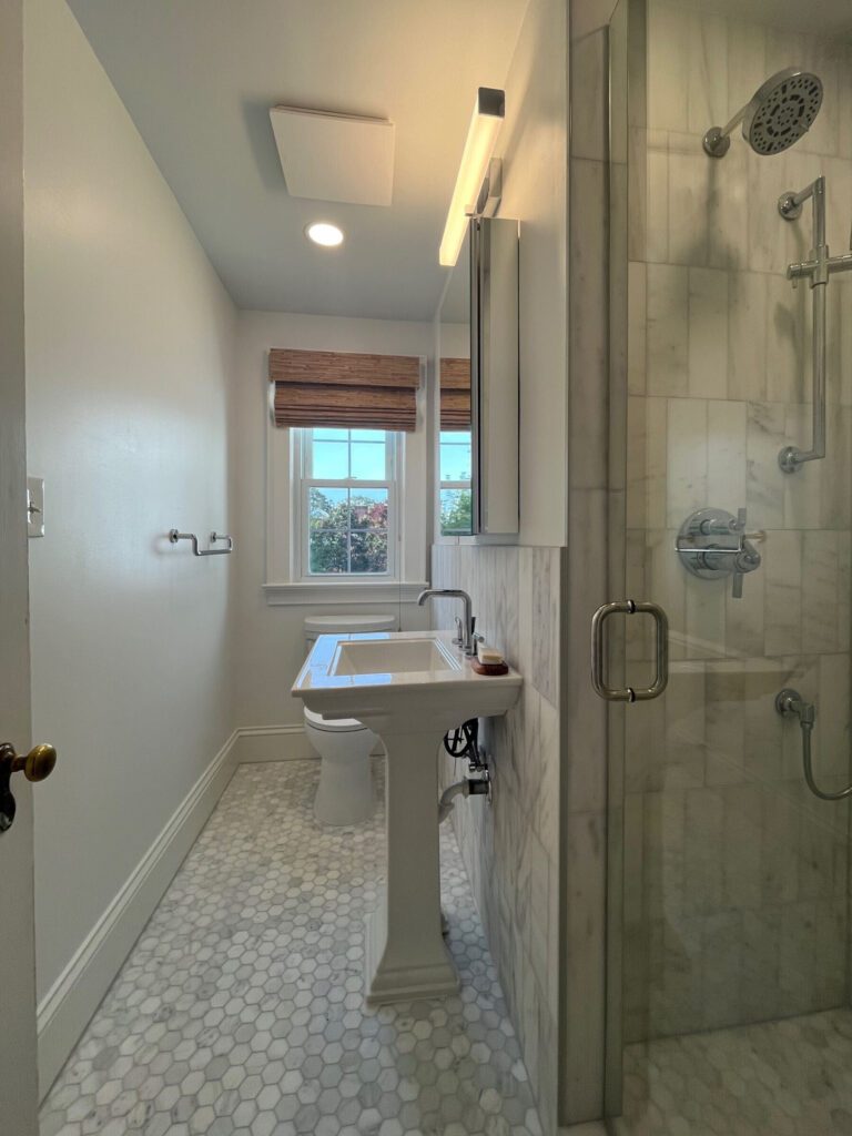 Working with the original layout of the upstairs bathroom, we leaned into the room’s unique footprint and created a serene, light-filled space with a timeless finish