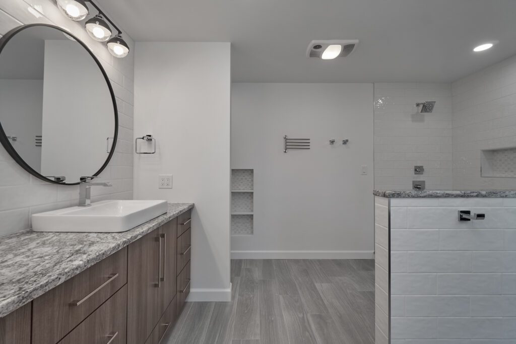 This bathroom remodel features Spirit porcelain tile by Florida Tile. The tile's beautiful, natural texture complements the room's modern elements, and its neutral tones tie seamlessly into the rest of the design.