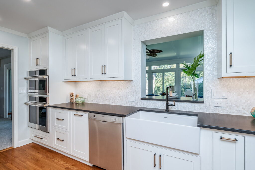 ustom Shiloh kitchen cabinetry with matte black and gold hardware providing ample storage in a Virginia Beach kitchen remodel by McDrake Remodeling.