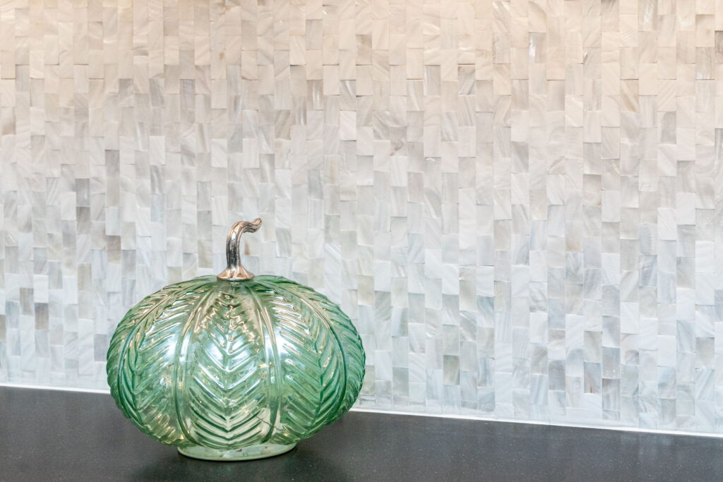 Elegant Viviano Mother of Pearl mosaic tile backsplash adding texture and luxury to a McDrake Remodeling kitchen in Virginia Beach.