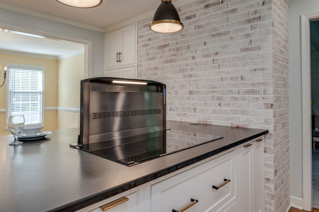 tate-of-the-art BEST D49M Series downdraft range hood system integrated into modern cooktop in a custom Virginia Beach kitchen remodel by McDrake Remodeling.