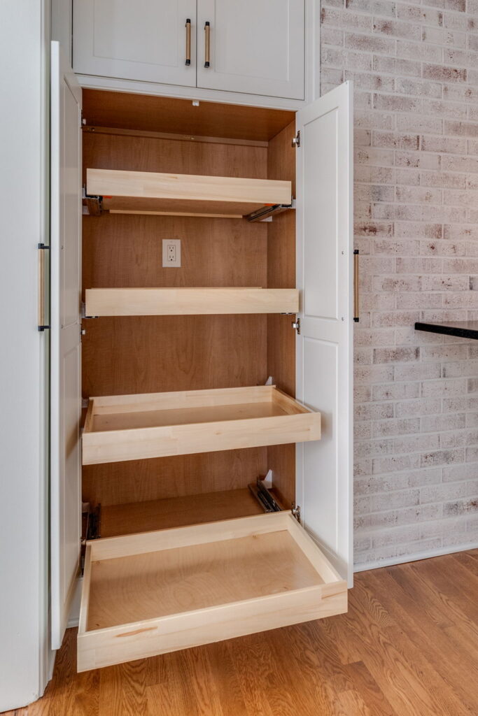 Custom Shiloh cabinetry featuring smart storage solutions, mixed metal hardware, and organized drawers in a bright Virginia Beach kitchen remodel by McDrake Remodeling.