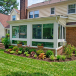 Finished Betterliving vinyl four-season sunroom overlooking the backyard in Poquoson, Virginia.